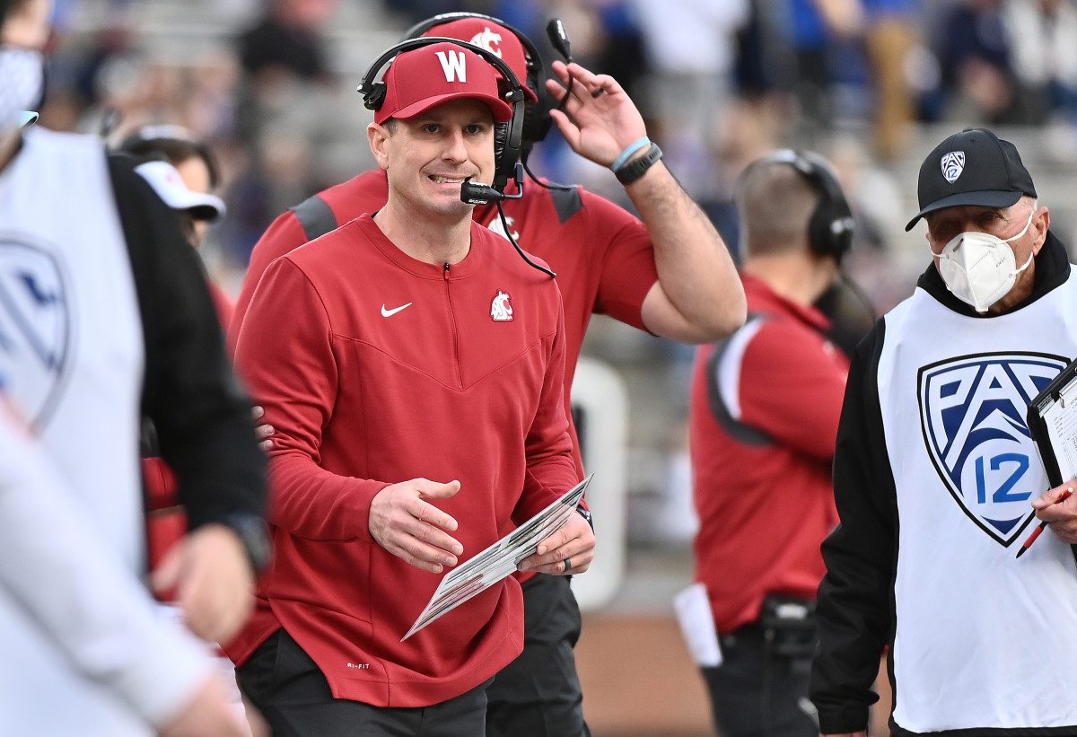 Washington State interim head coach Jake Dickert reacts after a play against BYU.