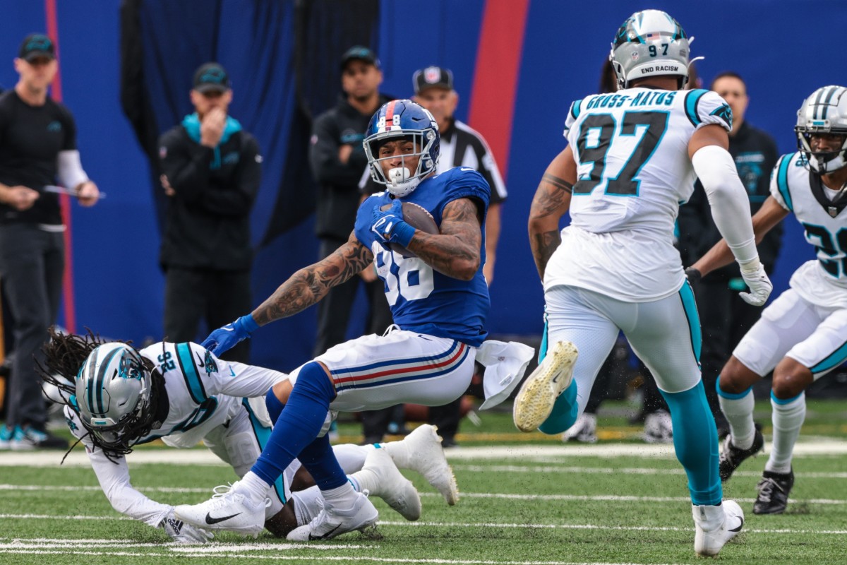 Oct 24, 2021; East Rutherford, New Jersey, USA; New York Giants tight end Evan Engram (88) is tackled by Carolina Panthers cornerback Donte Jackson (26) during the second half at MetLife Stadium.