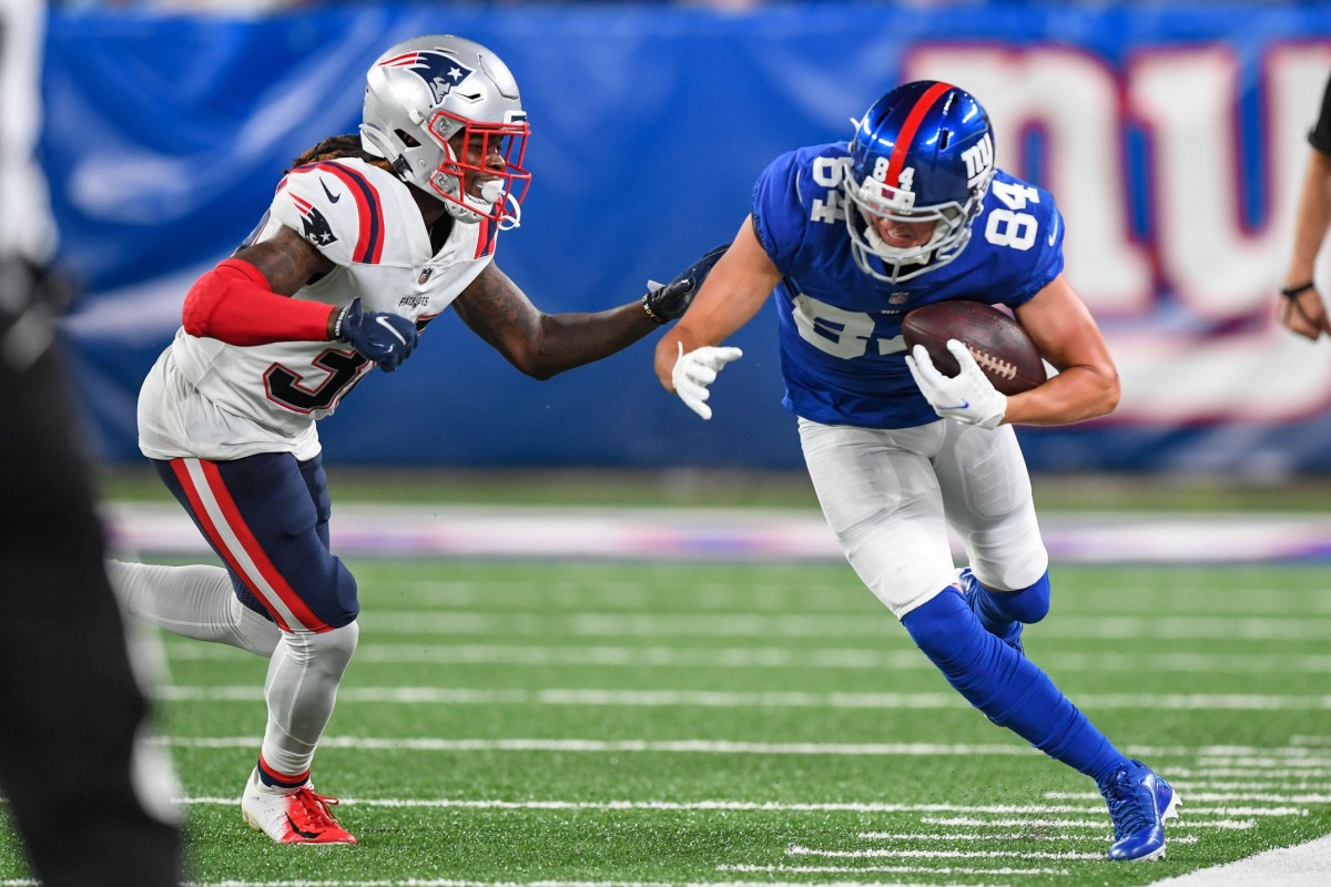 Aug 29, 2021; East Rutherford, New Jersey, USA; New York Giants wide receiver David Sills (84) catches the pass and makes a run defended by New England Patriots defensive back Dee Virgin (38) during the third quarter at MetLife Stadium.