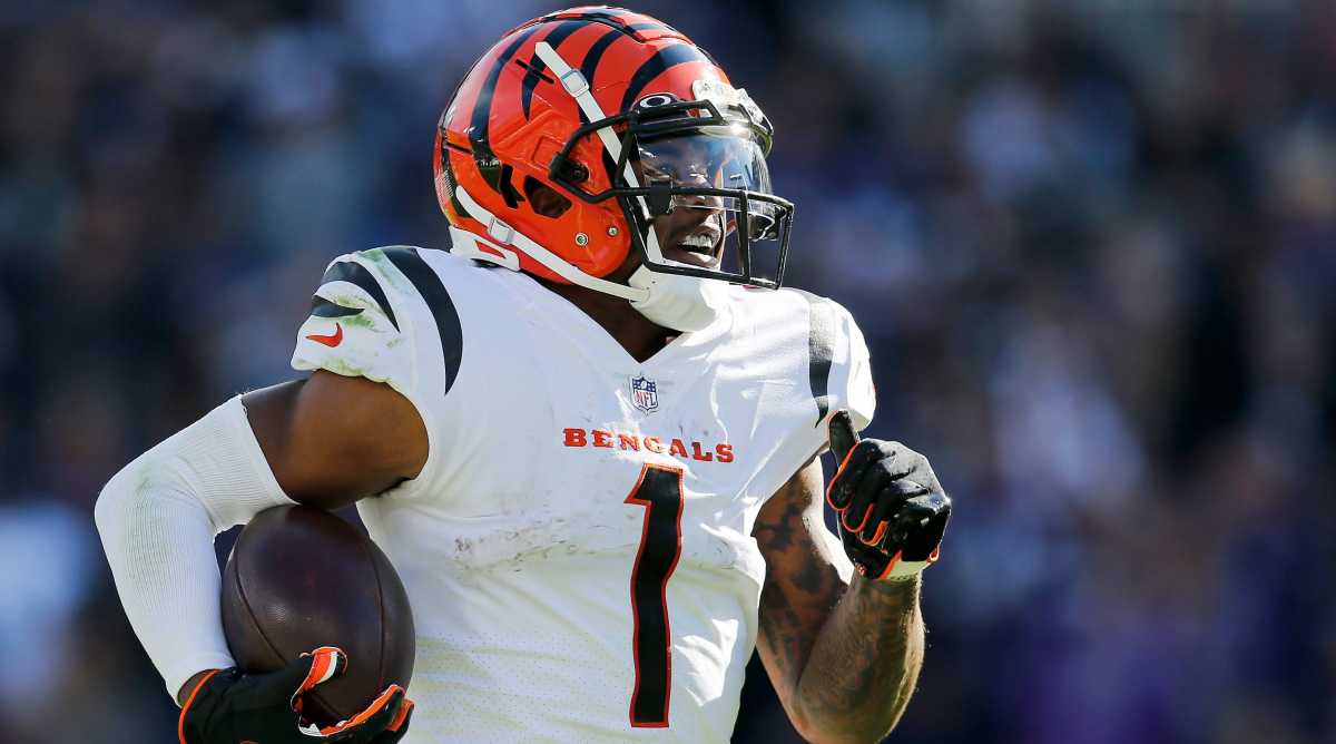 Cincinnati Bengals wide receiver Ja'Marr Chase (1) breaks tackles as he takes a reception 82 yards for a touchdown in the third quarter of the NFL Week 7 game between the Baltimore Ravens