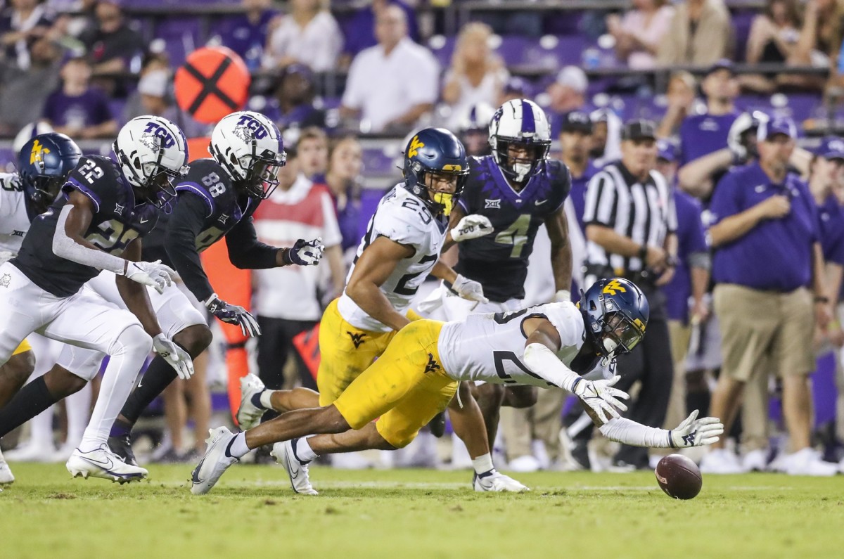 Oct 23, 2021; Fort Worth, Texas, USA; West Virginia Mountaineers defensive back Charles Woods (29) dives to recover a fumble during the fourth quarter against the TCU Horned Frogs at Amon G. Carter Stadium.