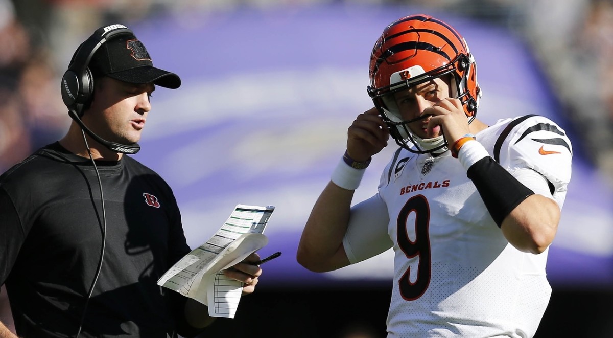 Oct 24, 2021; Baltimore, MD, USA; Cincinnati Bengals quarterback Joe Burrow (9) talks with head coach Zac Taylor during an official review in the third quarter of the NFL Week 7 game between the Baltimore Ravens and the Cincinnati Bengals at M&T Bank Stadium in Baltimore on Sunday, Oct. 24, 2021. Mandatory Credit: Sam Greene-USA TODAY Sports
