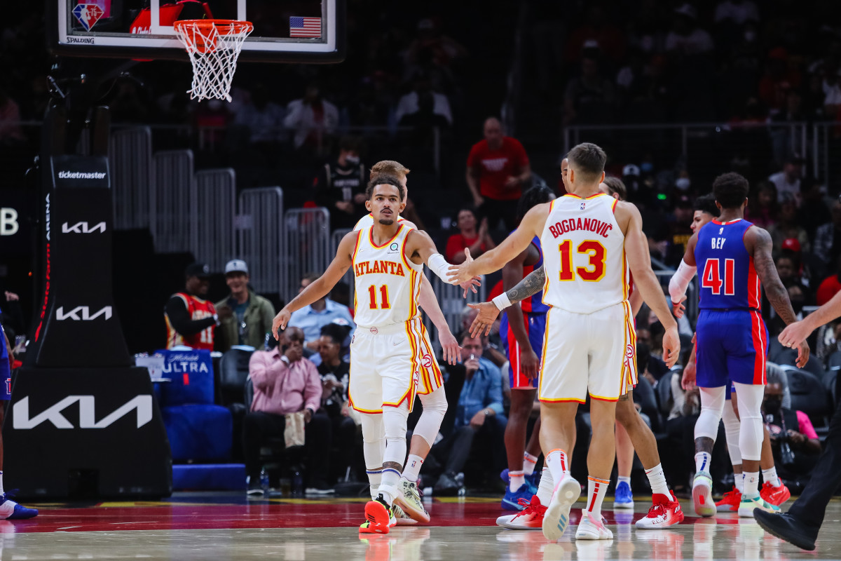 Atlanta Hawks guard Trae Young (11) high fives guard Bogdan Bogdanovic (13) during the first quarter against the Detroit Pistons at State Farm Arena.