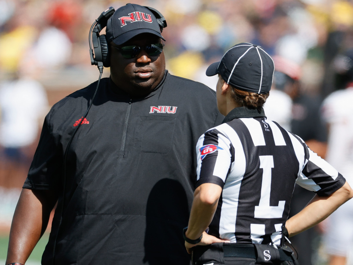 Northern Illinois Huskies head coach Thomas Hammock talks to the linesman during the game against the Michigan Wolverines at Michigan Stadium.