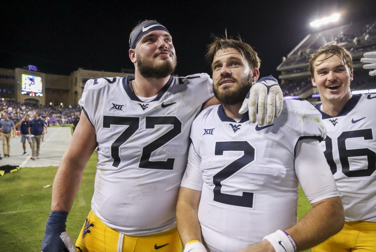 Oct 23, 2021; Fort Worth, Texas, USA; West Virginia Mountaineers offensive lineman Doug Nester (72) celebrates with West Virginia Mountaineers quarterback Jarret Doege (2) after defeating the TCU Horned Frogs at Amon G. Carter Stadium.