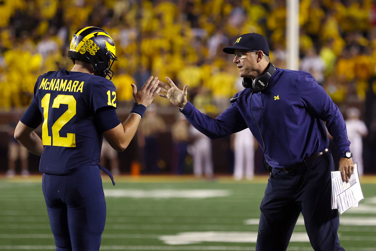 QB Cada McNamara and Jim Harbaugh slap hands