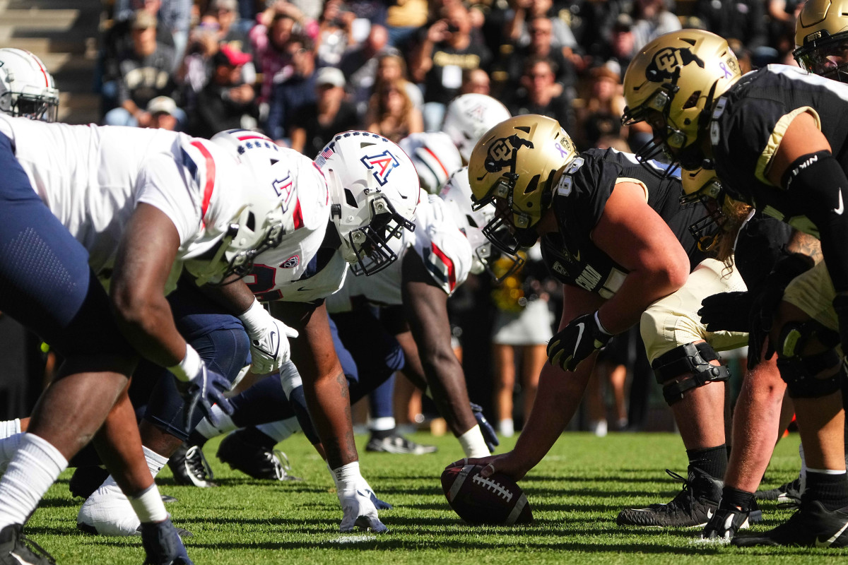 Members of the Arizona Wildcats line up across from the Colorado Buffaloes.