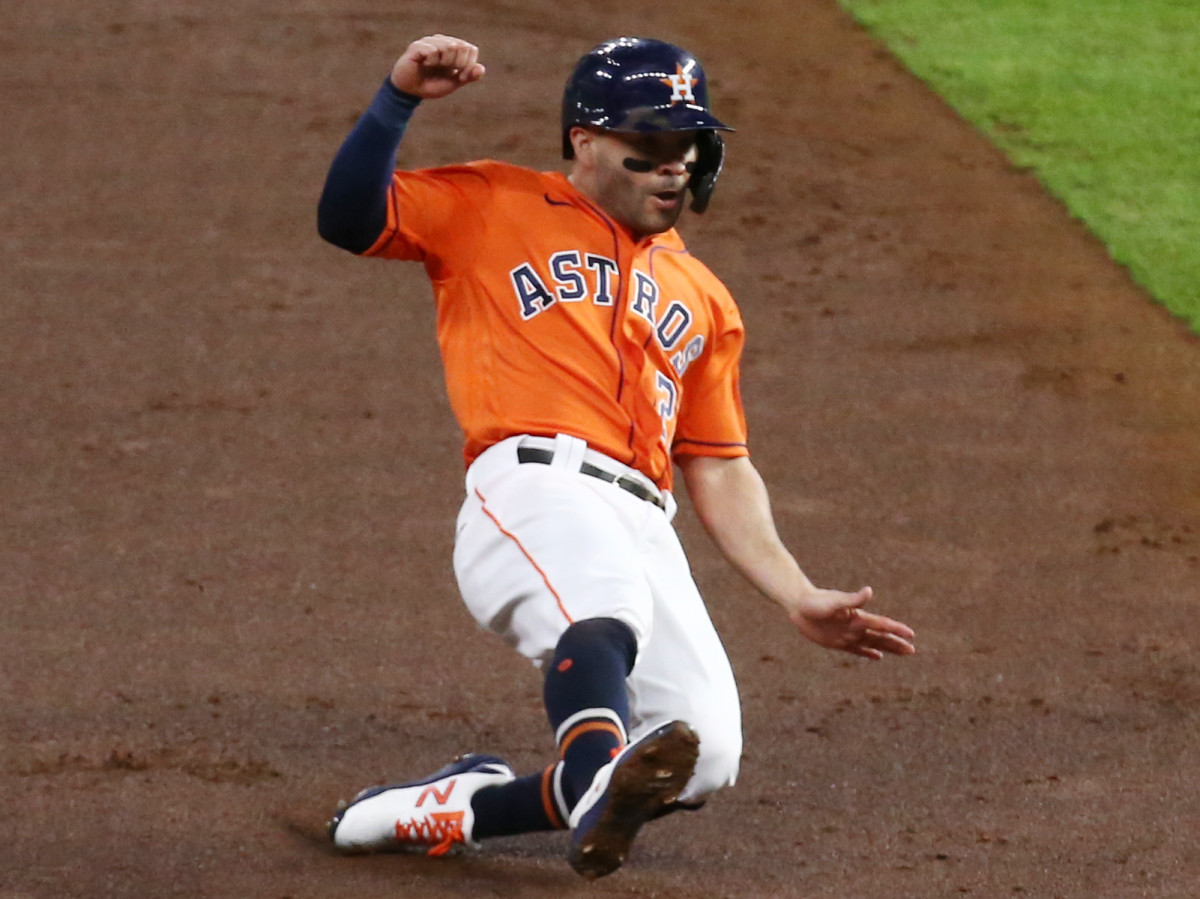 Houston Astros second baseman Jose Altuve tags up and slides into third base against the Atlanta Braves during the first inning in game two of the 2021 World Series at Minute Maid Park