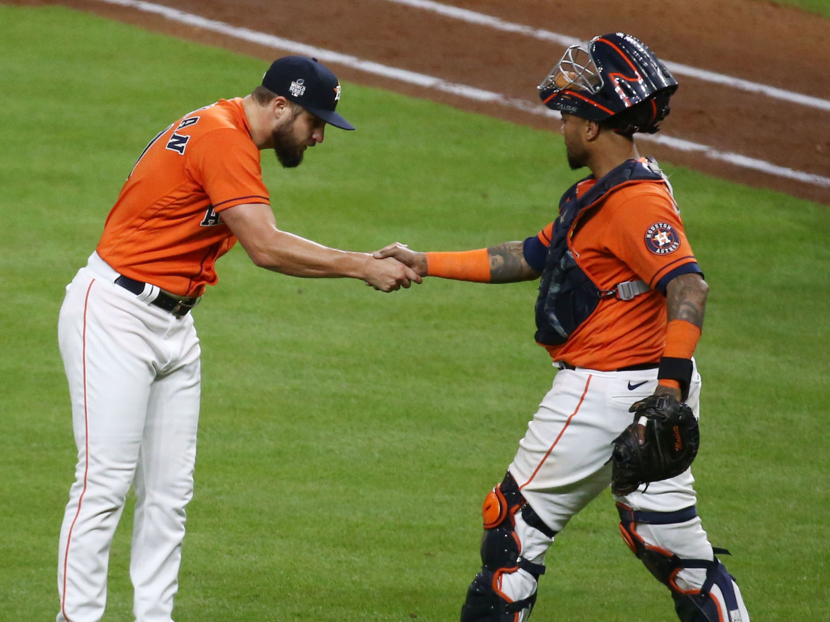 Houston Astros relief pitcher Kendall Graveman (31) shakes hands with catcher Martin Maldonado (15) after defeating the Atlanta Braves in game two of the 2021 World Series at Minute Maid Park.