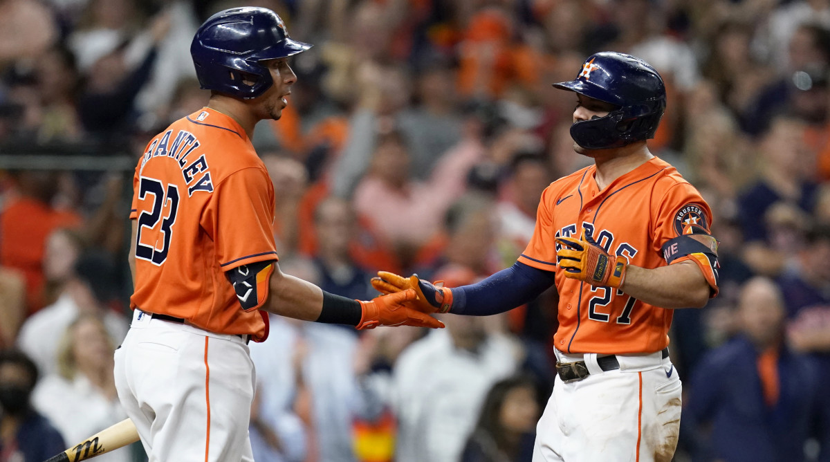 Oct 27, 2021; Houston, TX, USA; Houston Astros second baseman Jose Altuve (27) celebrates with left fielder Michael Brantley (23) after hitting a solo home run against the Atlanta Braves during the seventh inning in game two of the 2021 World Series at Minute Maid Park.