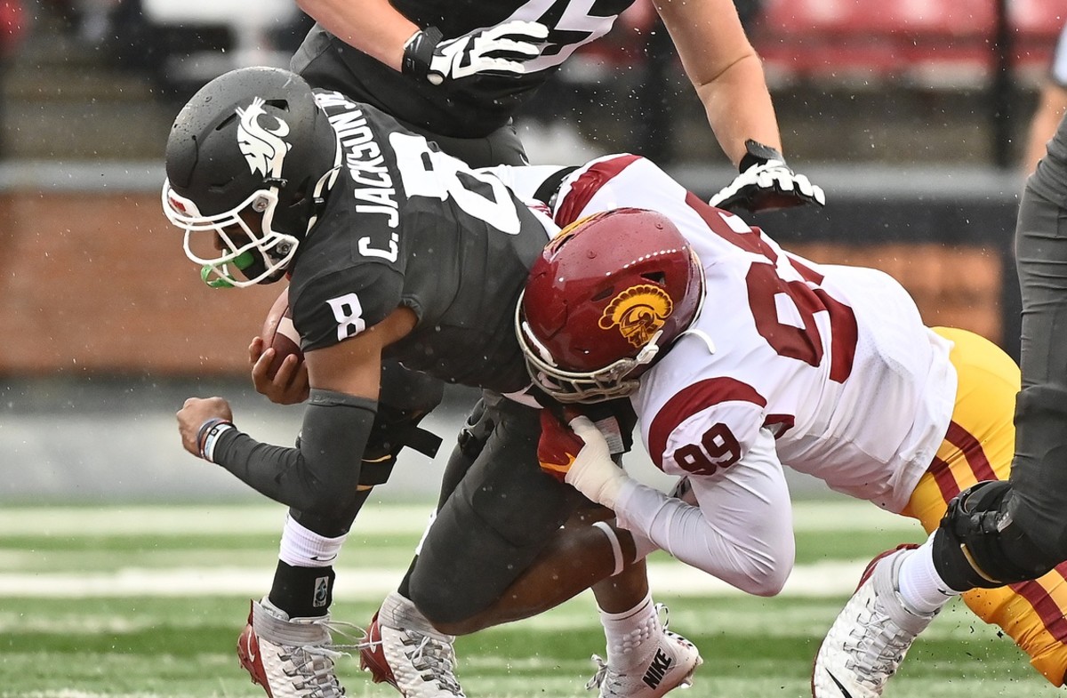 Washington State Cougars wide receiver Calvin Jackson Jr. (8) is tackled after a first down by USC Trojans linebacker Drake Jackson (99) in the first half at Gesa Field at Martin Stadium.