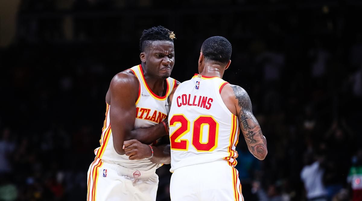 Atlanta Hawks' John Collins and Clint Capelapng