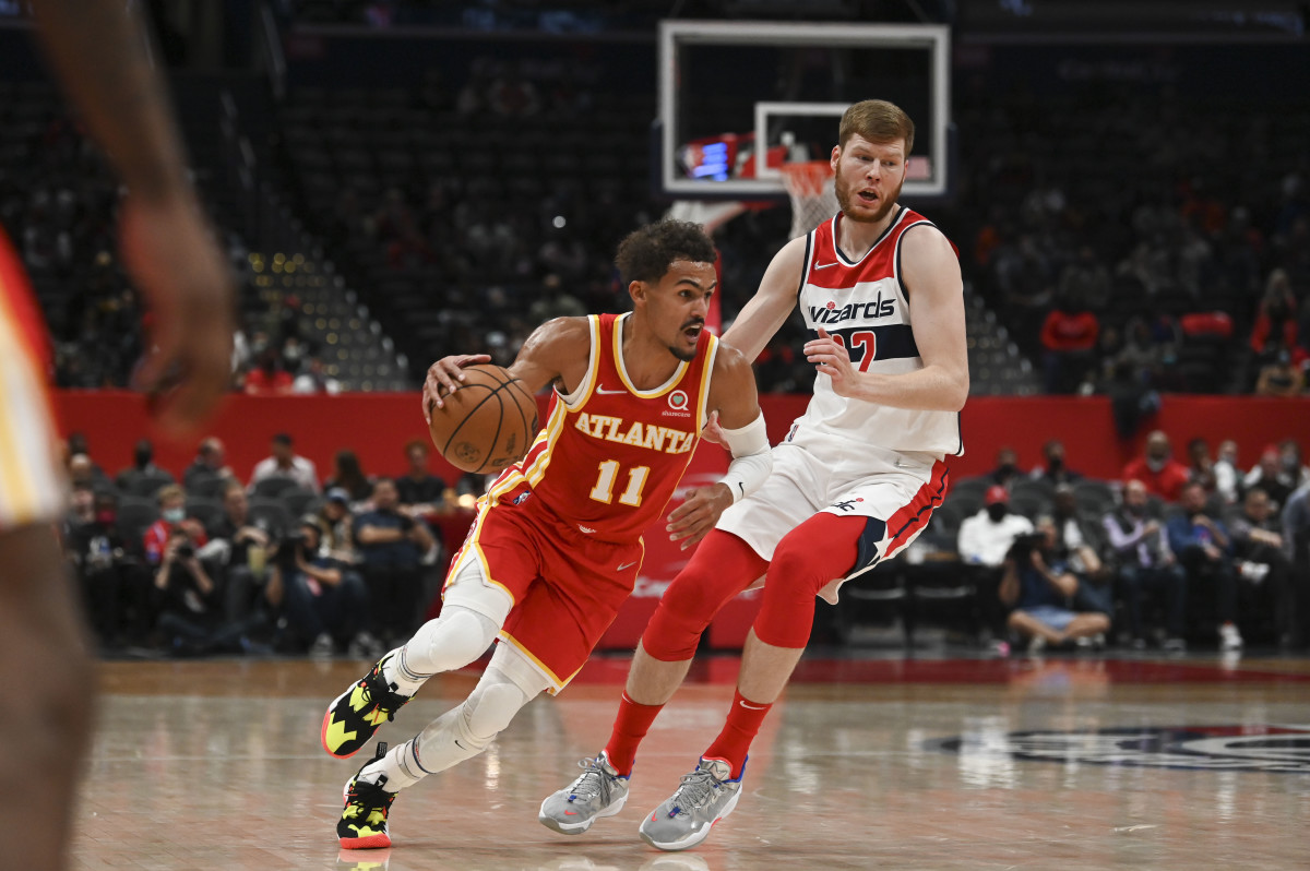 Atlanta Hawks guard Trae Young (11) dribbles as Washington Wizards forward Davis Bertans (42) defends during the first half at Capital One Arena.