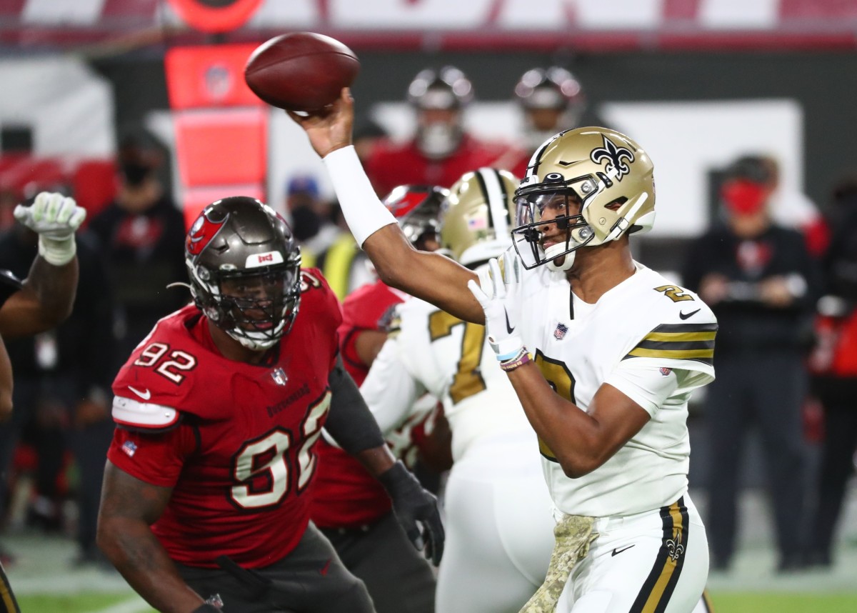 New Orleans Saints quarterback Jameis Winston (2) throws the ball as Tampa Bay defensive end William Gholston (92) rushes. Mandatory Credit: Kim Klement-USA TODAY Sports