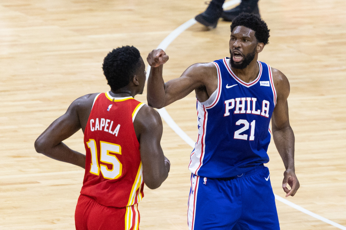 Philadelphia 76ers center Joel Embiid (21) reacts against Atlanta Hawks center Clint Capela (15) after a guard Ben Simmons (not pictured) dunk during the first quarter in game five of the second round of the 2021 NBA Playoffs at Wells Fargo Center.