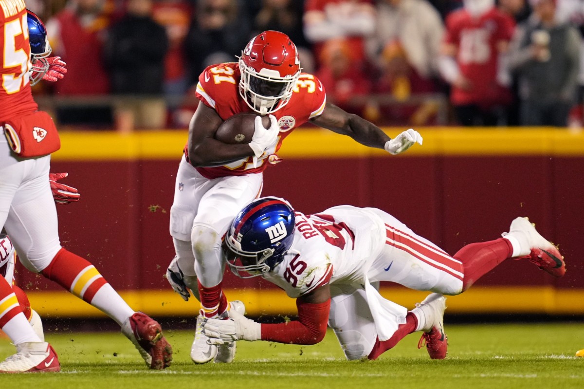 Kansas City Chiefs running back Darrel Williams (31) runs the ball while defended by New York Giants linebacker Quincy Roche (95) during the first quarter at GEHA Field at Arrowhead Stadium.