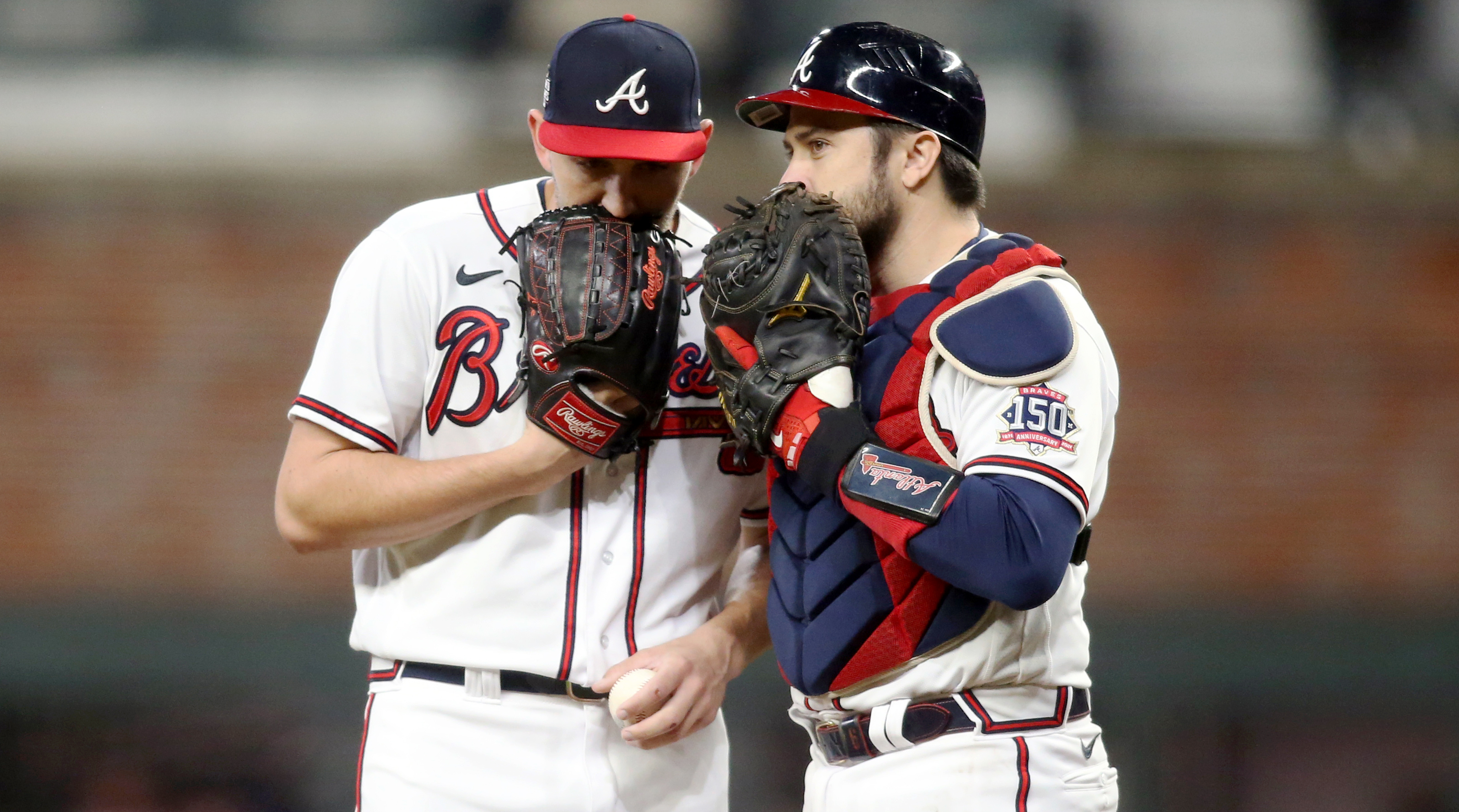 Oct 30, 2021; Atlanta, Georgia, USA; Atlanta Braves relief pitcher Dylan Lee (74) talks to catcher Travis d'Arnaud (16) prior to game four of the 2021 World Series against the Houston Astros at Truist Park.