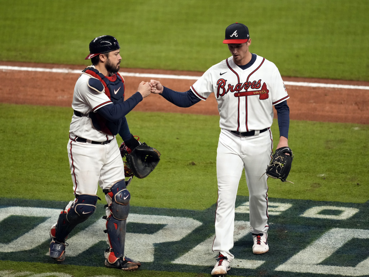 Oct 30, 2021; Atlanta, Georgia, USA; Atlanta Braves starting pitcher Kyle Wright (30) fist bumps catcher Travis d'Arnaud (16) after right gets out of the fifth inning of game four of the 2021 World Series against the Houston Astros at Truist Park.