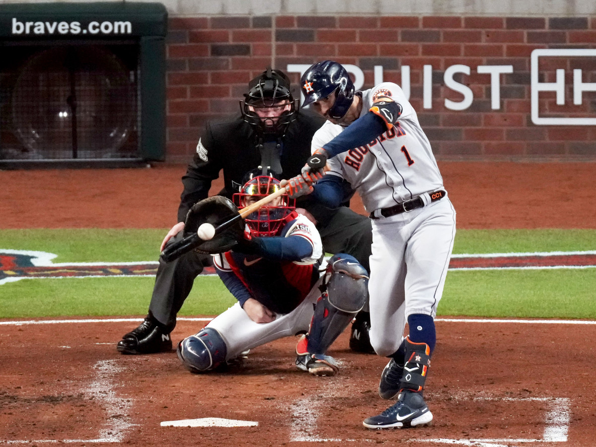 Oct 31, 2021; Atlanta, Georgia, USA; Houston Astros shortstop Carlos Correa (1) hits an RBI double against the Atlanta Braves during the third inning of game five of the 2021 World Series at Truist Park.