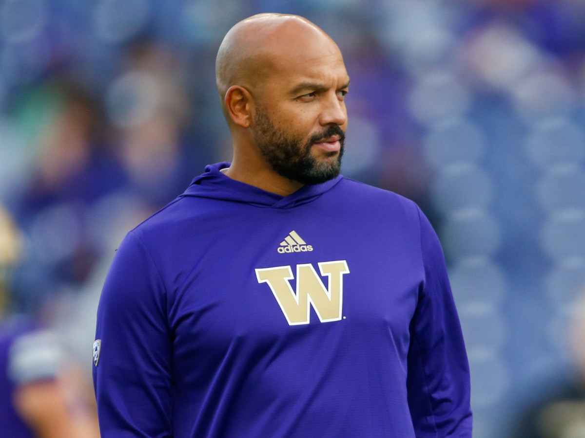Washington Huskies head coach Jimmy Lake watches pregame warmups against the UCLA Bruins at Alaska Airlines Field at Husky Stadium.