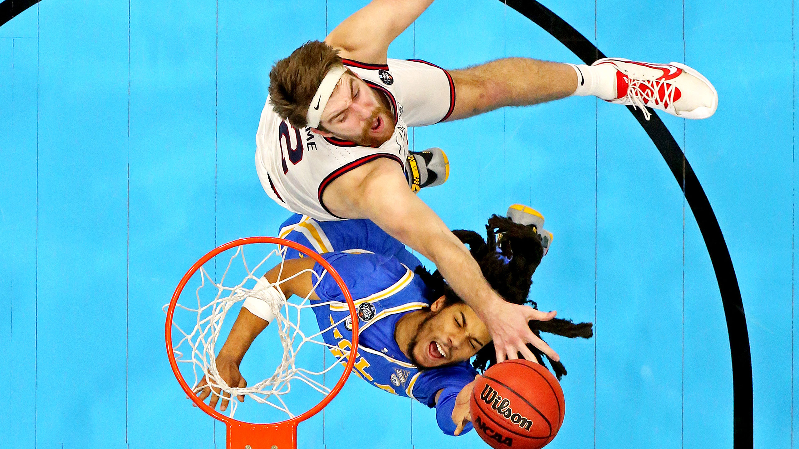 UCLA's Drew Timme and UCLA's Tyger Campbell battle under the basket