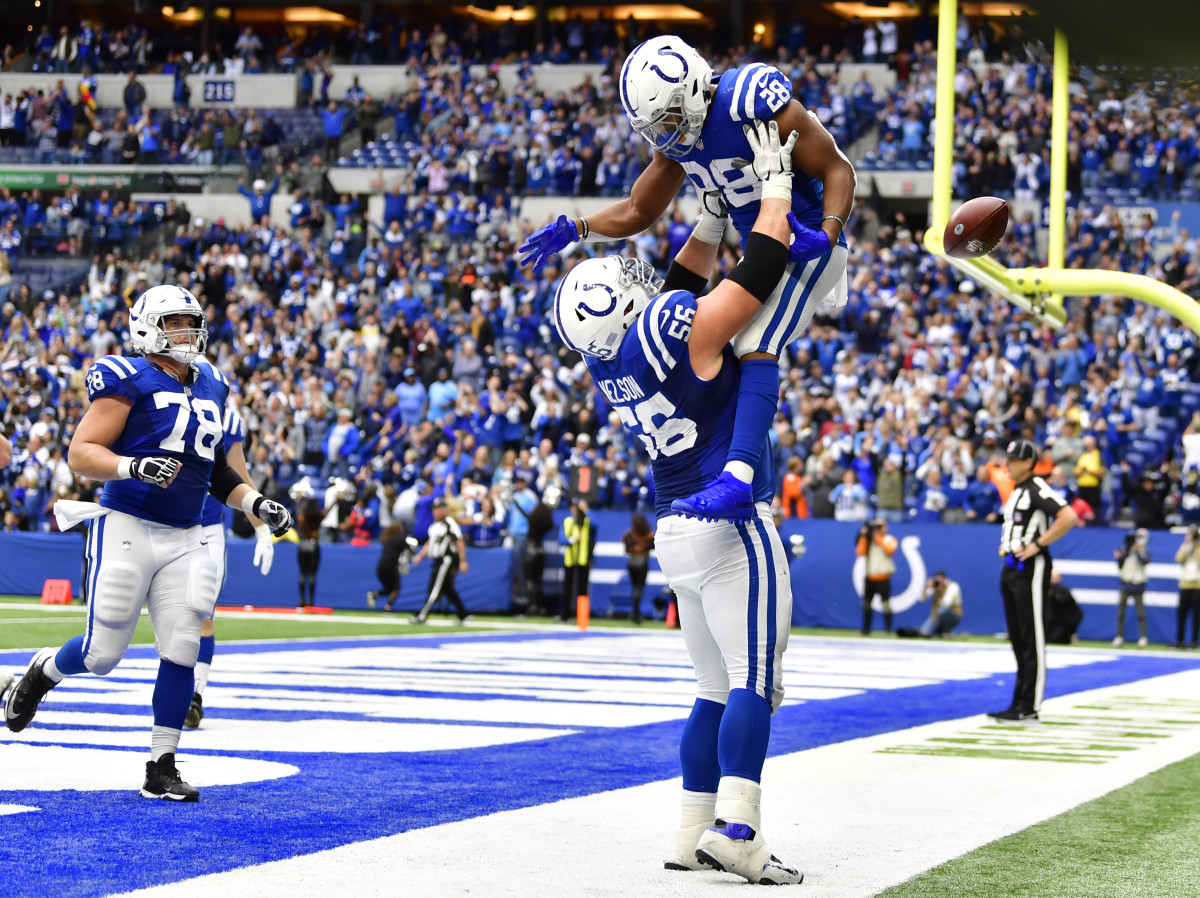 Oct 31, 2021; Indianapolis, Indiana, USA; Indianapolis Colts guard Quenton Nelson (56) lifts Indianapolis Colts running back Jonathan Taylor (28) into the air after he scores a touchdown during the second half at Lucas Oil Stadium. Titans won 34-31.