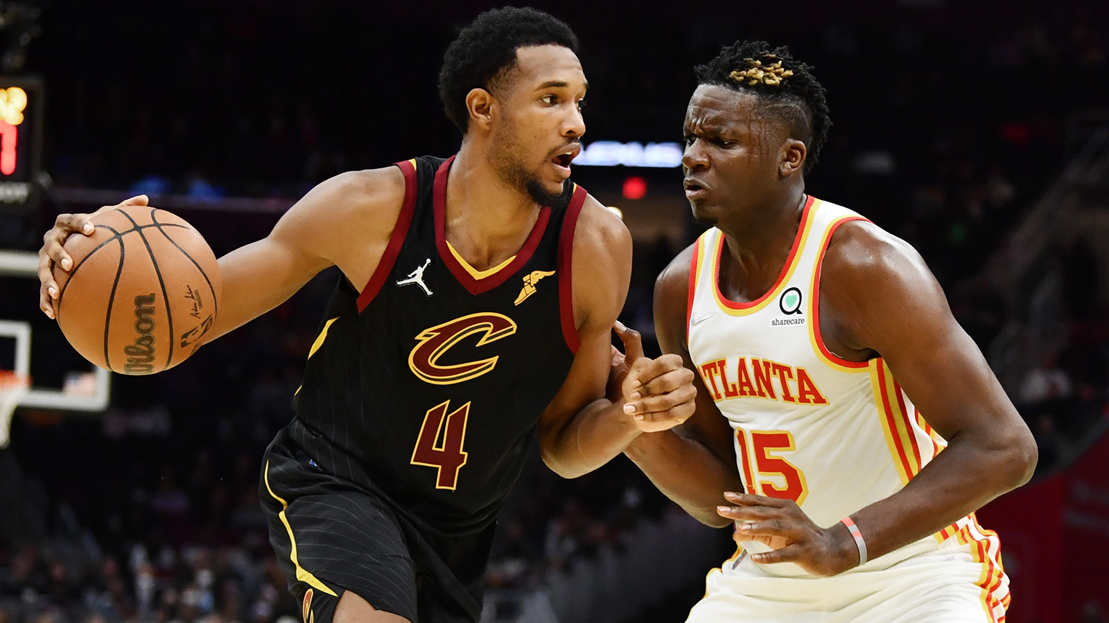 Evan Mobley (4) drives to the basket against Atlanta Hawks center Clint Capela.