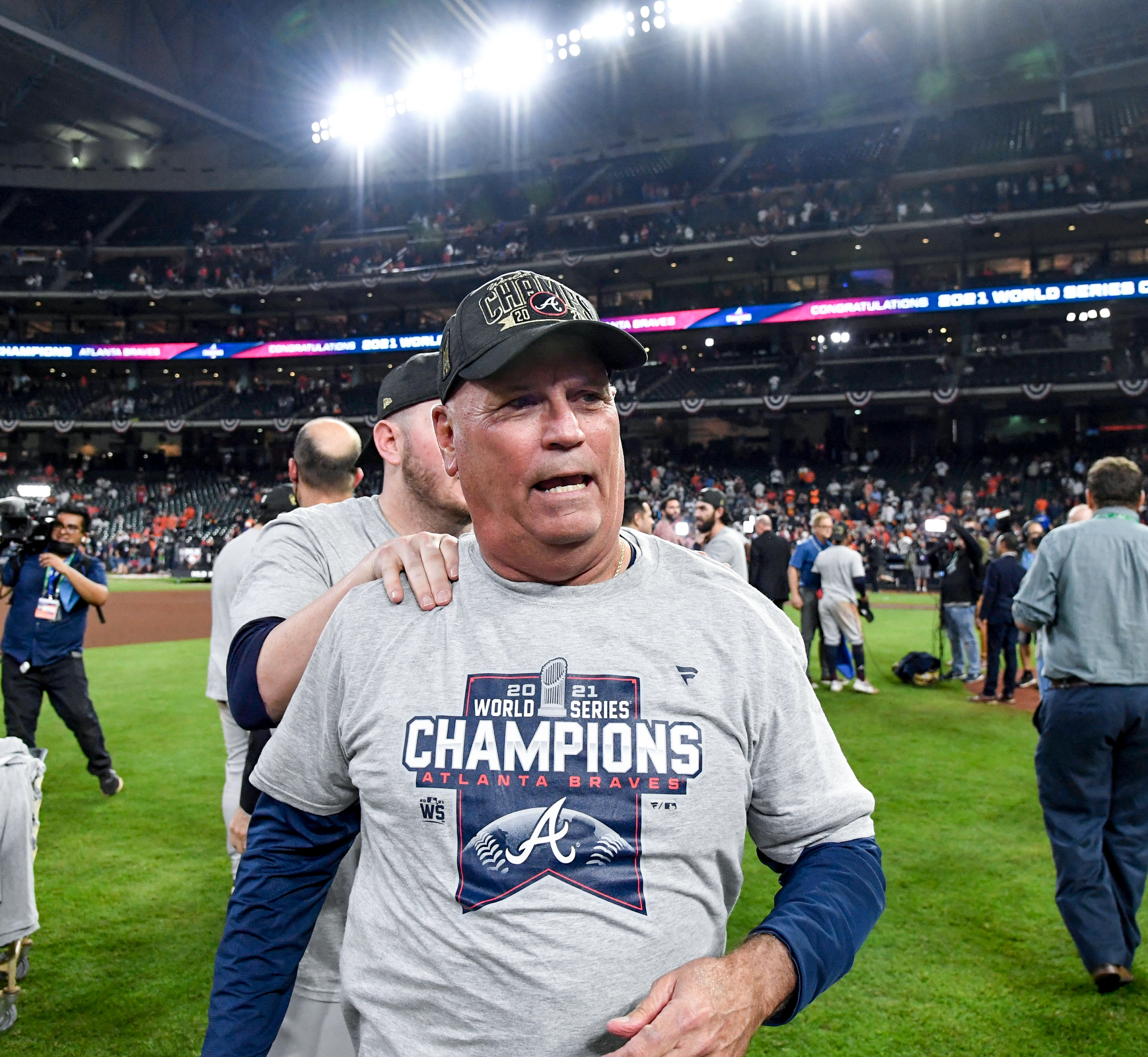 Braves manager Brian Snitker, on the field wearing championship apparel, after Atlanta beat the Astros, 7–0, in Game 6 to win the 2021 World Series at Minute Maid Park.