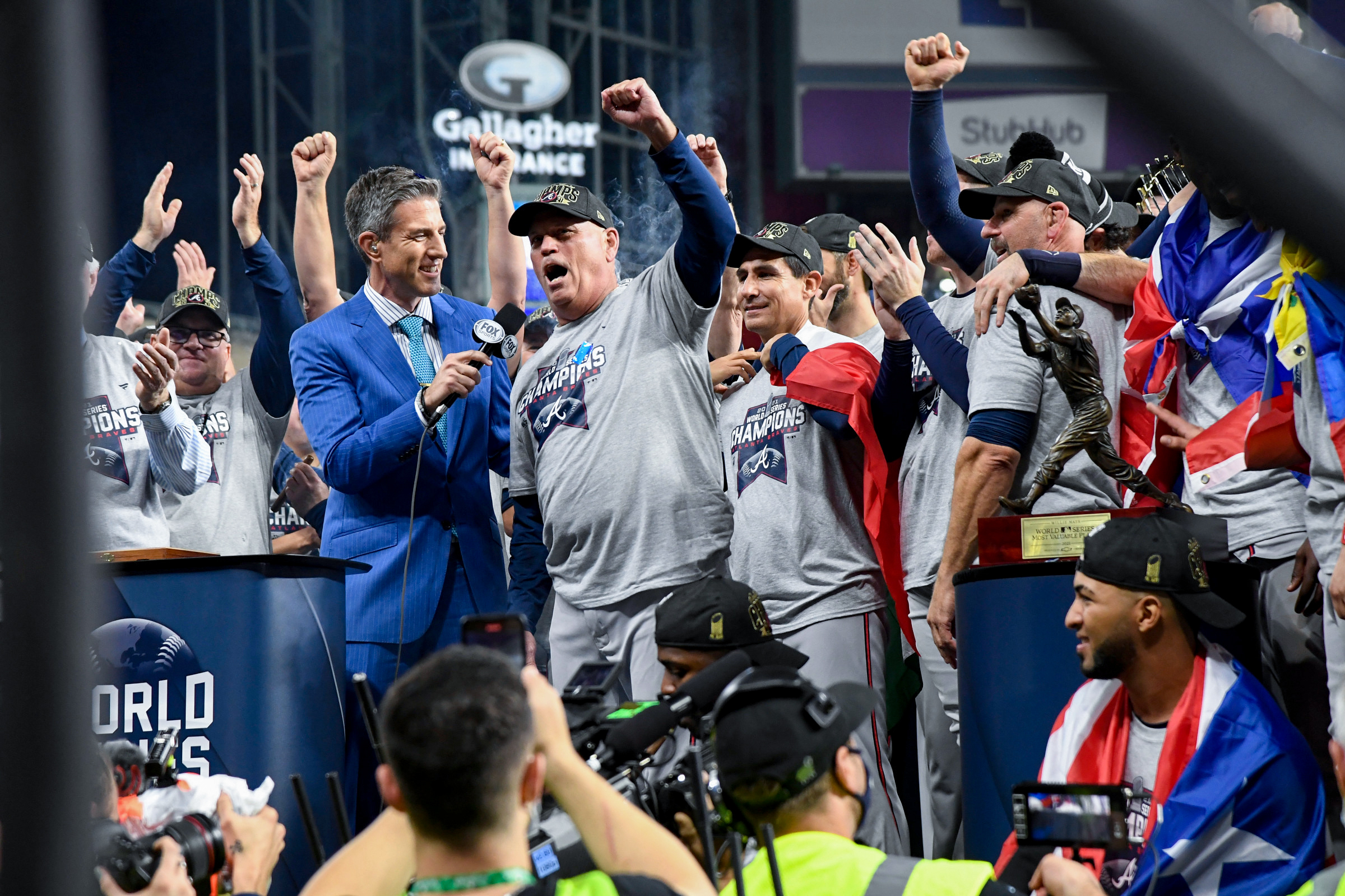 Braves manager Brian Snitker raises his left arm in triumph after Atlanta beat the Astros to win its first World Series title since 1995.