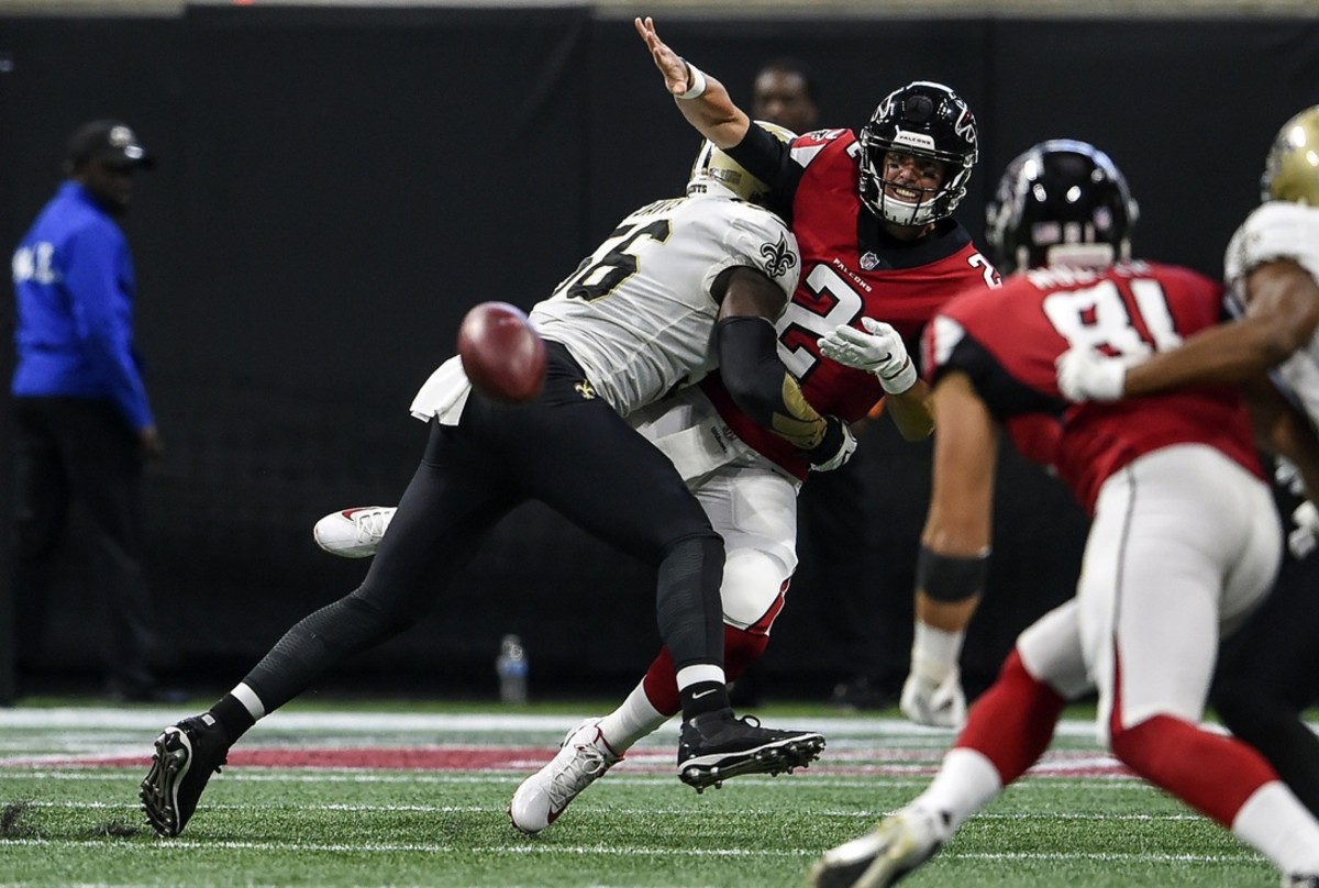 Atlanta Falcons quarterback Matt Ryan (2) releases the ball as he is hit by New Orleans Saints linebacker Demario Davis (56). Mandatory Credit: Dale Zanine-USA TODAY Sports