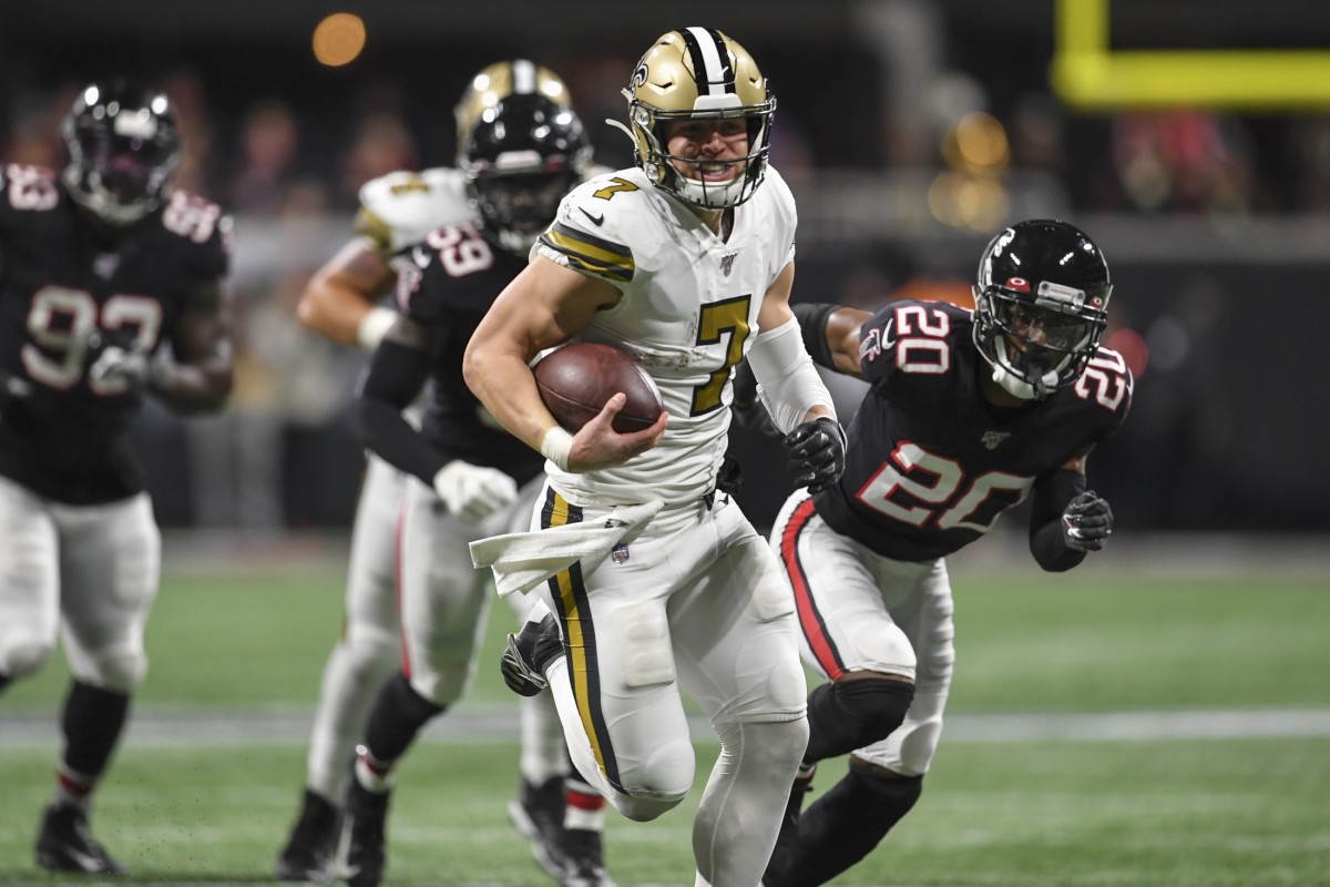 New Orleans Saints quarterback Taysom Hill (7) runs through the Atlanta Falcons defense. Mandatory Credit: Dale Zanine-USA TODAY Sports
