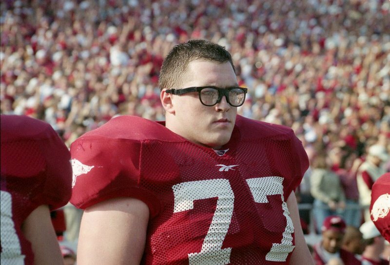 Brandon Burlsworth is on the sideline of a Razorback game wearing his iconic glasses. 