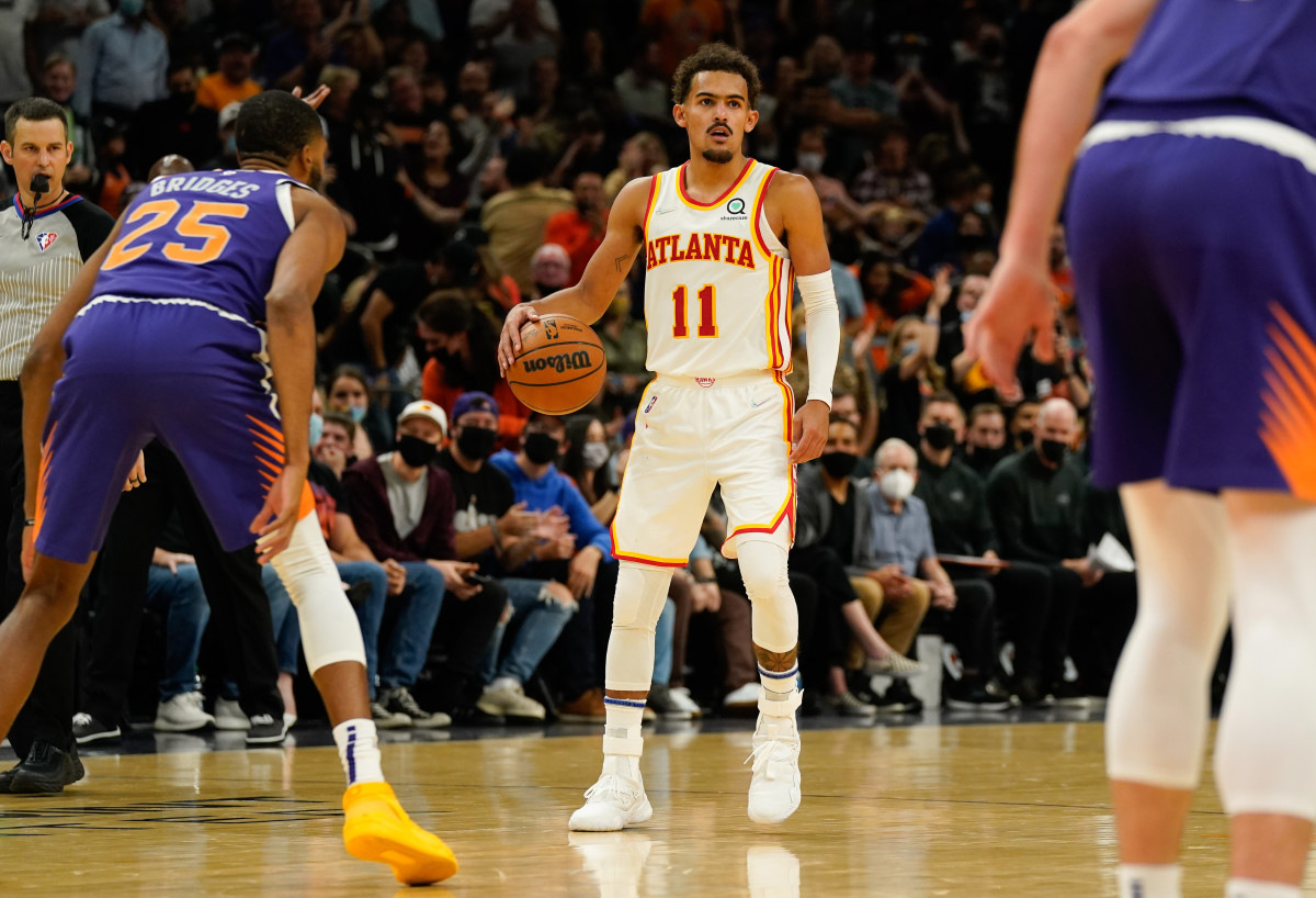 Atlanta Hawks guard Trae Young (11) brings the ball up court against the Phoenix Suns in the second half at Footprint Center.