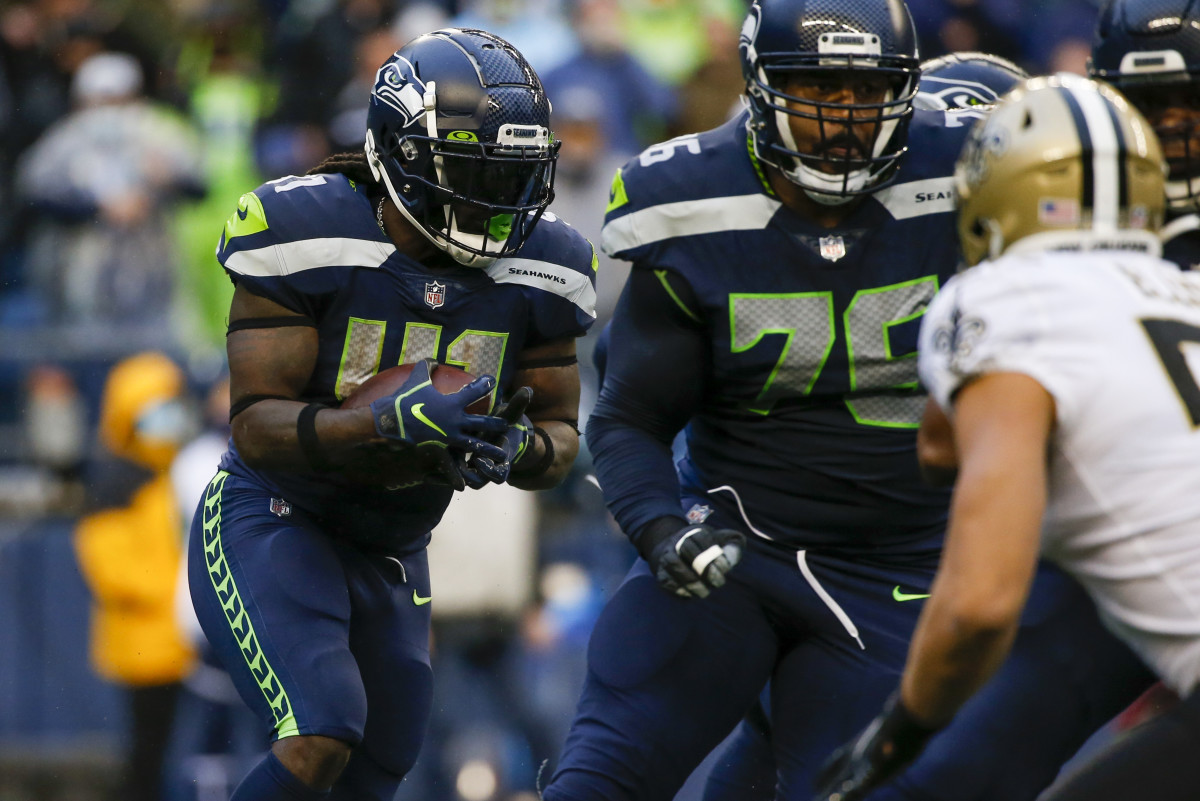 Seattle Seahawks running back Alex Collins (41) rushes against the New Orleans Saints during the first quarter at Lumen Field.