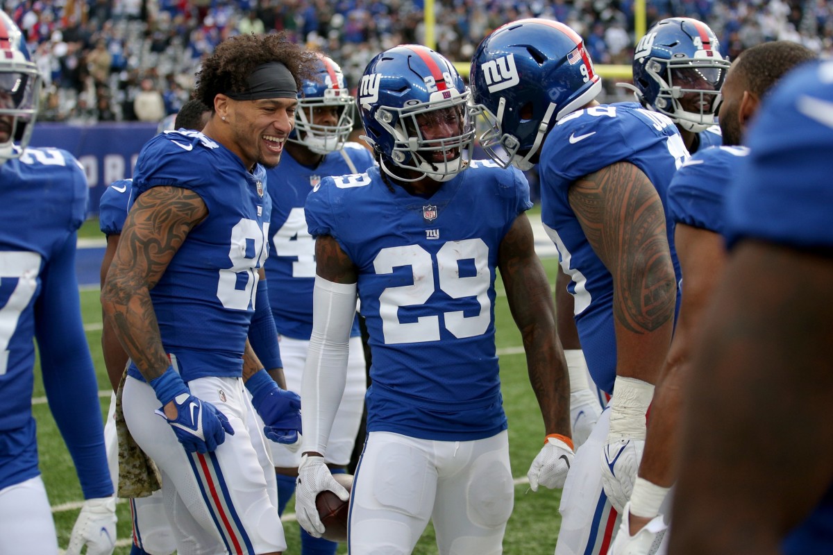 Nov 7, 2021; East Rutherford, New Jersey, USA; New York Giants free safety Xavier McKinney (29) celebrates his interception return for a touchdown against the Las Vegas Raiders with tight end Evan Engram (88) and nose tackle Austin Johnson (98) during the third quarter at MetLife Stadium.