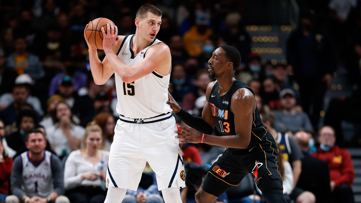 Denver Nuggets center Nikola Jokic (15) controls the ball as Miami Heat center Bam Adebayo (13) guards in the fourth quarter