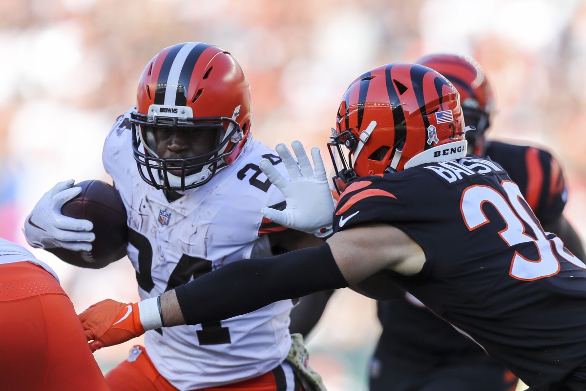 Nov 7, 2021; Cincinnati, Ohio, USA; Cleveland Browns running back Nick Chubb (24) runs with the ball against Cincinnati Bengals free safety Jessie Bates III (30) in the first half at Paul Brown Stadium. Mandatory Credit: Katie Stratman-USA TODAY Sports