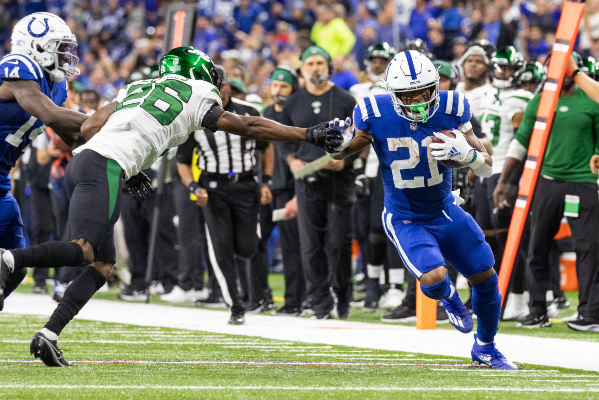Nov 4, 2021; Indianapolis, Indiana, USA; Indianapolis Colts running back Nyheim Hines (21) runs the ball while New York Jets cornerback Brandin Echols (26) defends in the second half at Lucas Oil Stadium.