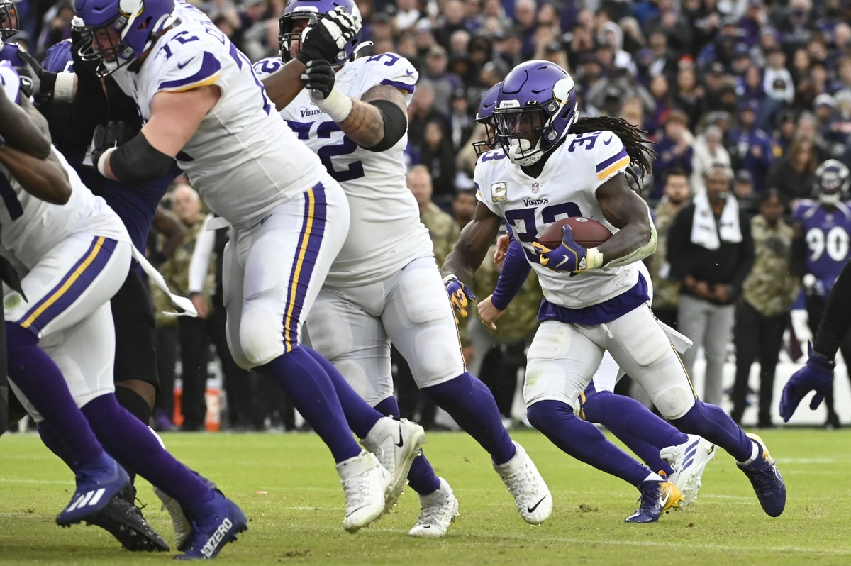 Nov 7, 2021; Baltimore, Maryland, USA; Minnesota Vikings running back Dalvin Cook (33) rushes behind the offensive line during the second half against the Baltimore Ravens at M&T Bank Stadium.