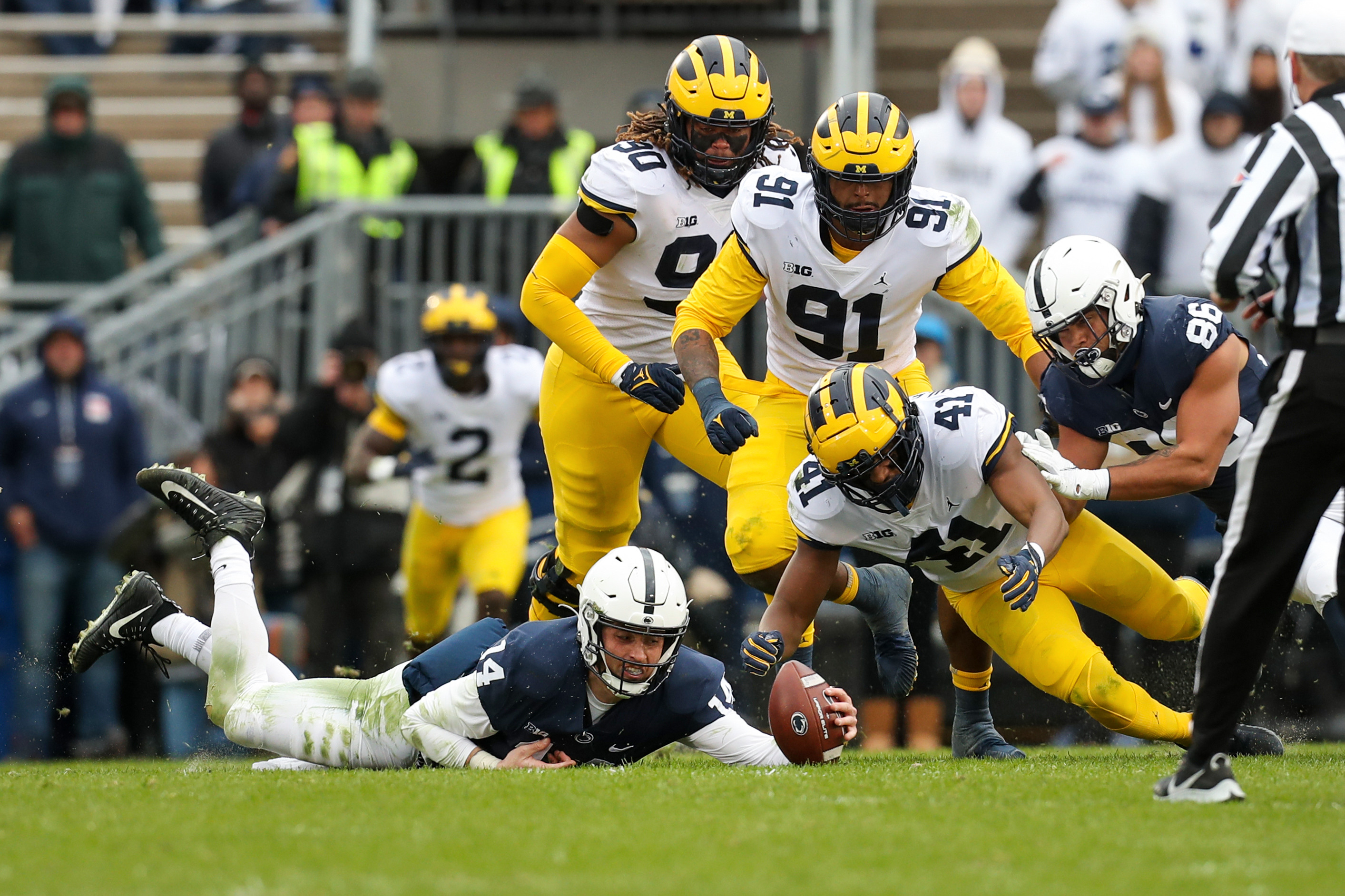 Penn State quarterback Sean Clifford recovers a fumble after being sacked in the first half against Michigan. (Matthew O'Haren/USA Today Sports)
