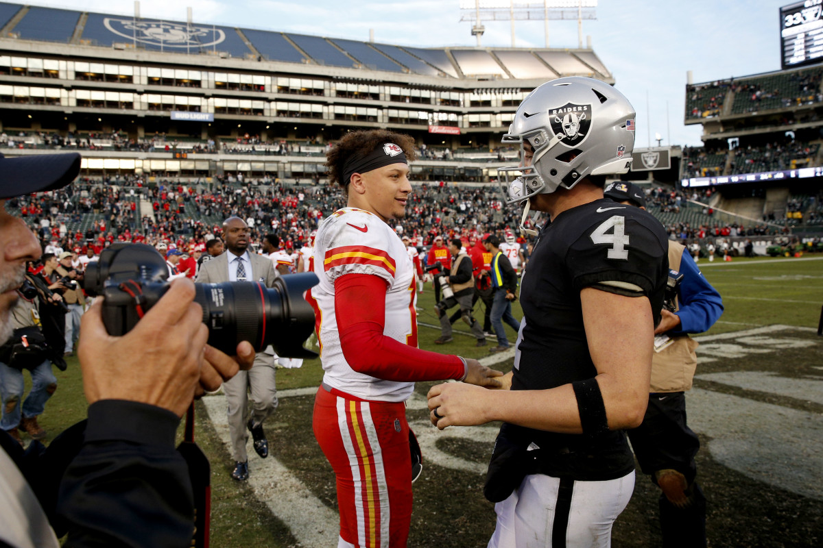 Dec 2, 2018; Oakland, CA, USA; Kansas City Chiefs quarterback Patrick Mahomes (15) meets with Oakland Raiders quarterback Derek Carr (4) after the game at Oakland Coliseum. Mandatory Credit: Cary Edmondson-USA TODAY Sports