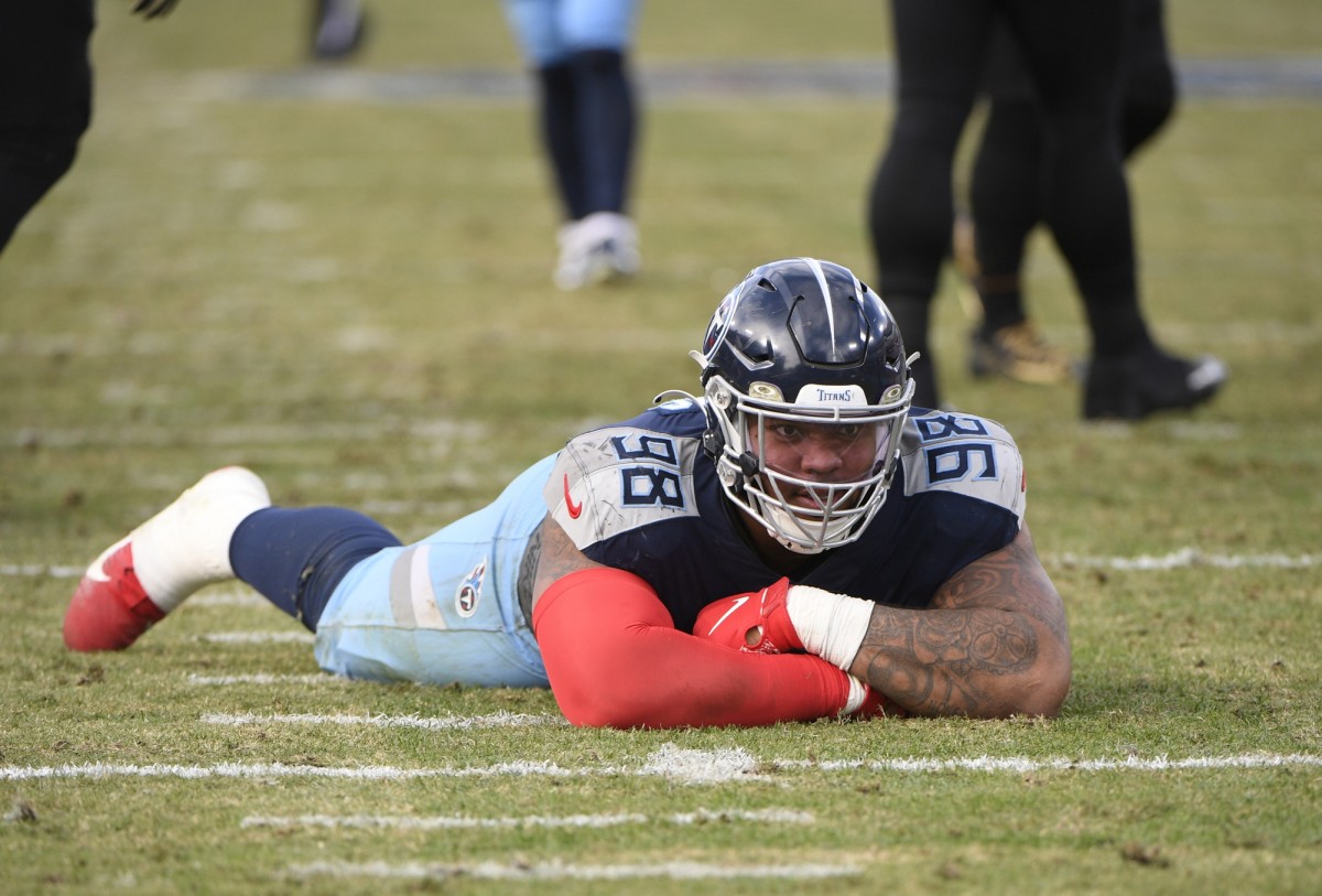 Tennessee Titans defensive tackle Jeffery Simmons (98) lays on the ground in celebration after the deflected pass of New Orleans Saints quarterback Trevor Siemian (15) during the second half at Nissan Stadium.