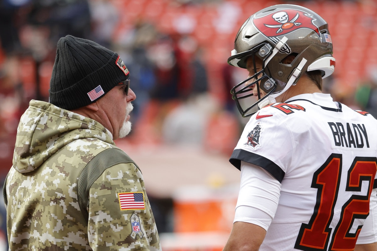 Nov 14, 2021; Landover, Maryland, USA; Tampa Bay Buccaneers head coach Bruce Arians (L) talks with Buccaneers quarterback Tom Brady (12) during warmups prior to the game against the Washington Football Team at FedExField.