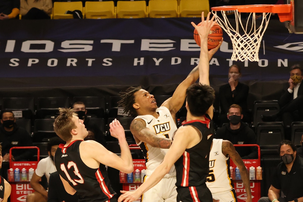 Mar 6, 2021; Richmond, Virginia, USA; VCU Rams guard Adrian Baldwin Jr. (1) shoots the ball as Davidson Wildcats forward Hyunjung Lee (1) defends in the second half in a semifinal of the Atlantic 10 conference tournament at Stuart C. Siegel Center. Mandatory Credit: Geoff Burke-USA TODAY Sports