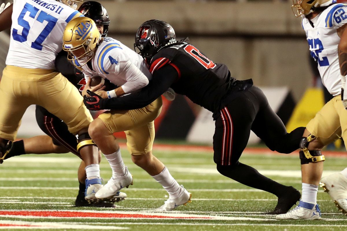 UCLA Bruins quarterback Ethan Garbers (4) is sacked by Utah Utes linebacker Devin Lloyd (0).
