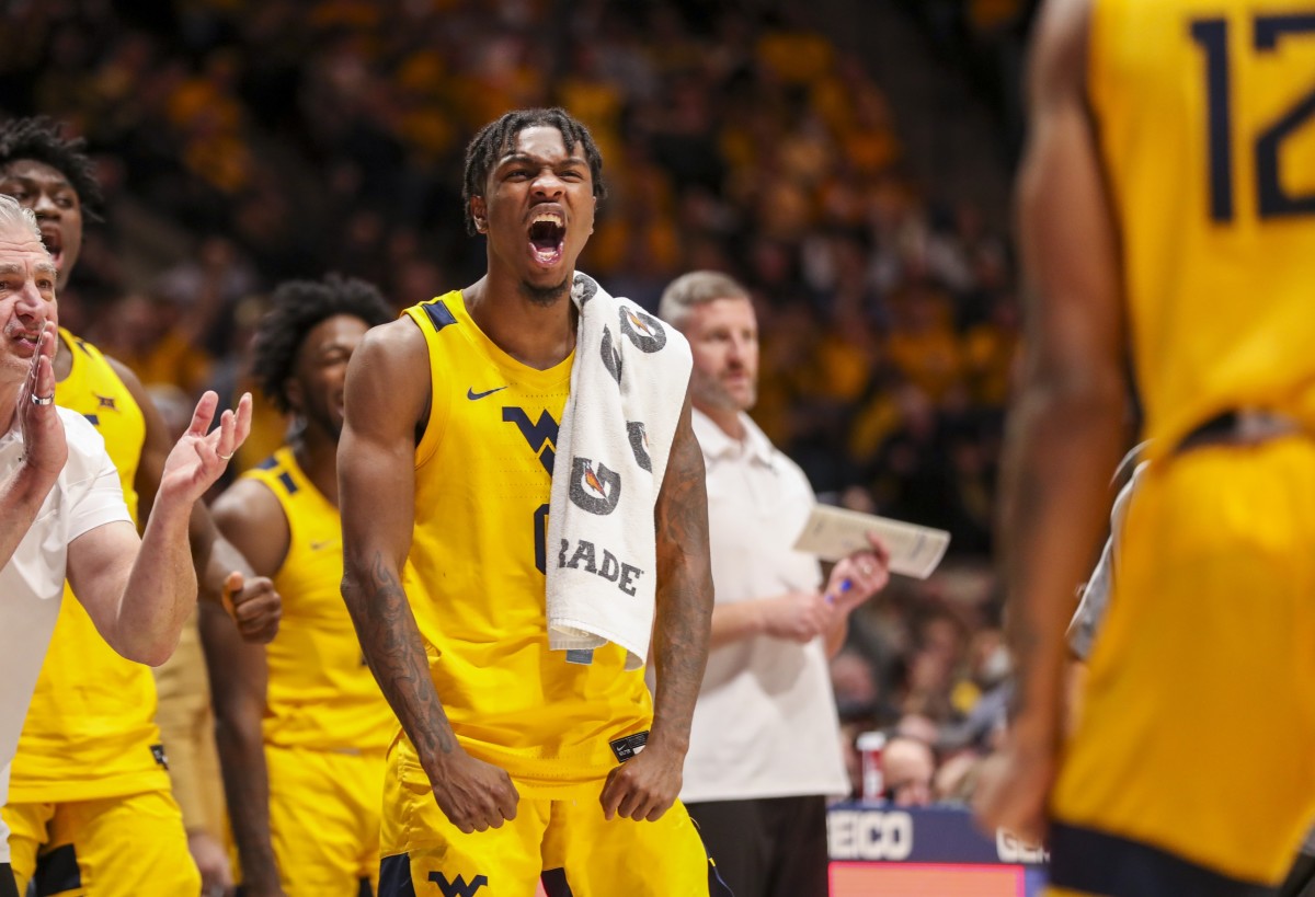Nov 12, 2021; Morgantown, West Virginia, USA; West Virginia Mountaineers guard Kedrian Johnson (0) celebrates from the bench during the second half against the Pittsburgh Panthers at WVU Coliseum.