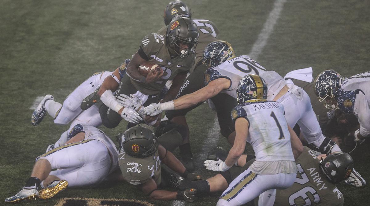 Dec 12, 2020; West Point, New York, USA; Army Black Knights quarterback Tyhier Tyler (2) carries the ball as Navy Midshipmen defensive tackle Jackson Perkins (96) defends during the second half at Michie Stadium.
