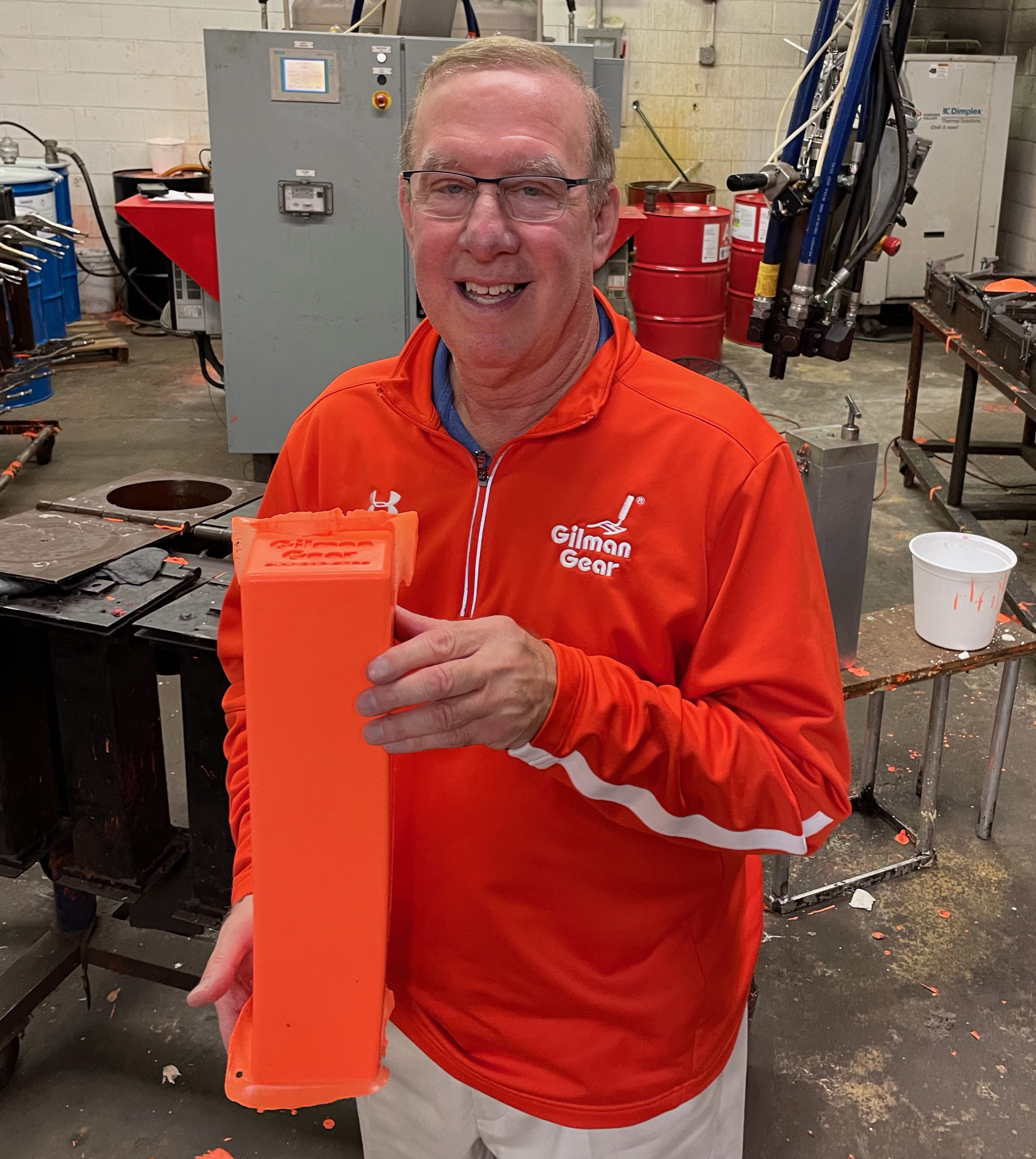 Neil Gilman of pylon manufacturer Gilman Gear holds a pylon in his factory