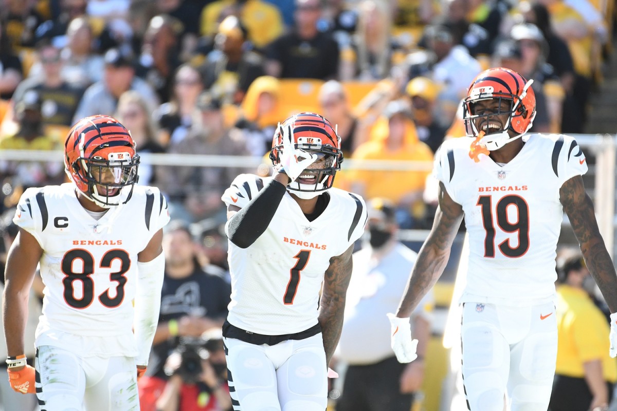 Sep 19, 2021; Pittsburgh, Pennsylvania, USA; Cincinnati Bengals wide receiver Ja Marr Chase (1) celebrates a nine-yard touchdown pass with wide receiver Tyler Boyd (83) and wide receiver Auden Tate (19) against the Pittsburgh Steelers during the third quarter at Heinz Field