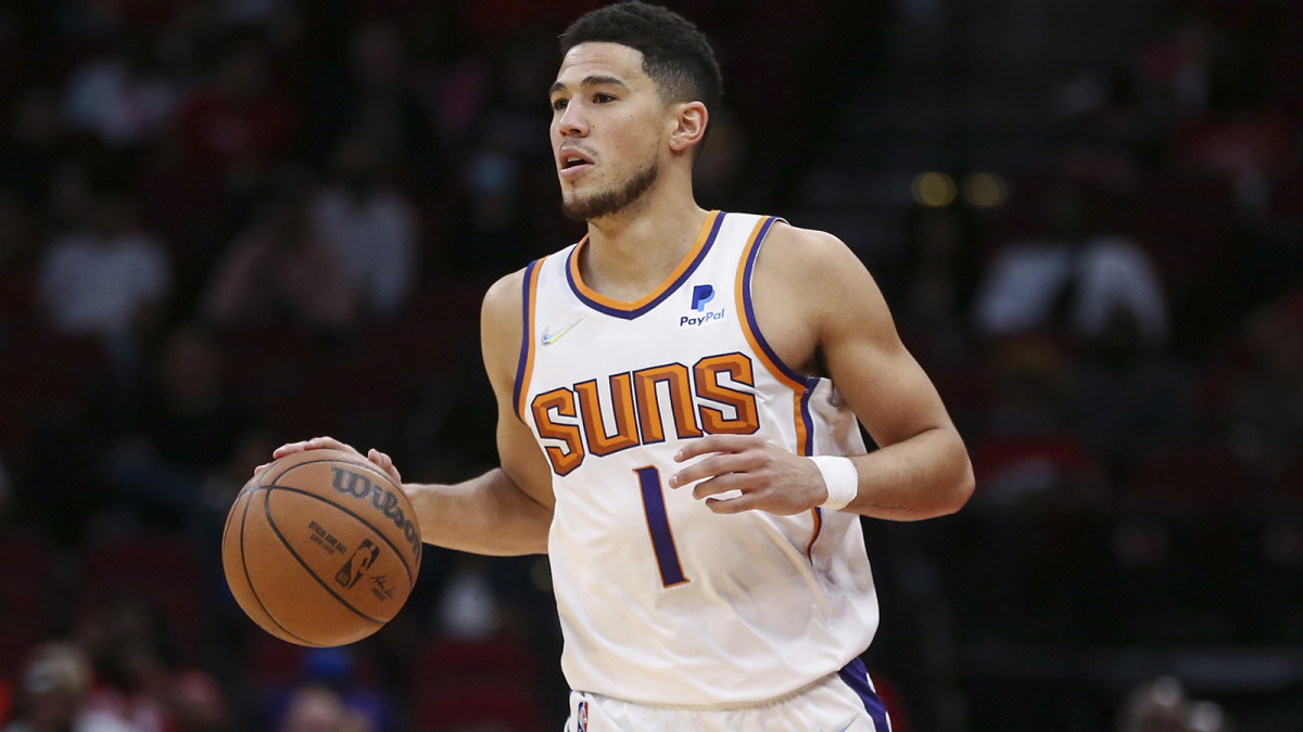 Phoenix Suns guard Devin Booker (1) brings the ball up the court during the first quarter against the Houston Rockets.